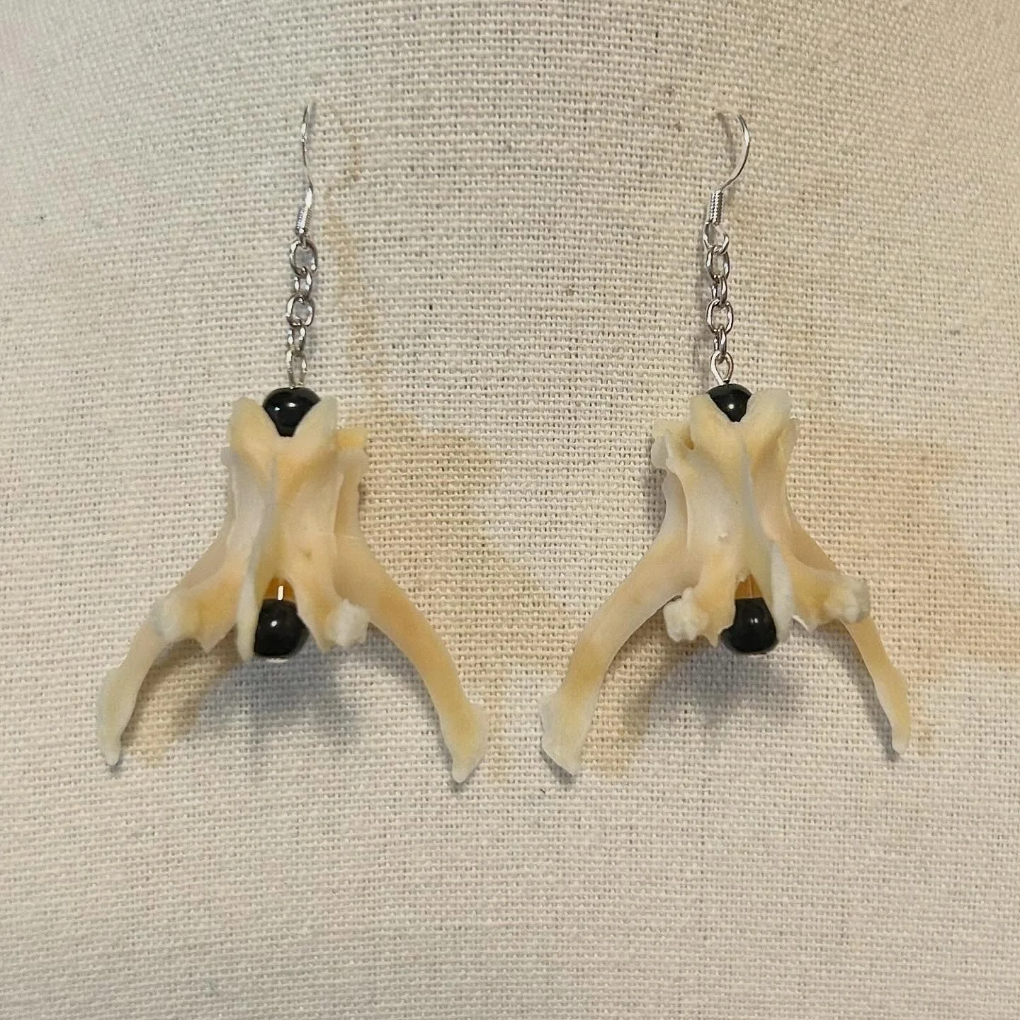 Rabbit vertebra with black upcycled beads.