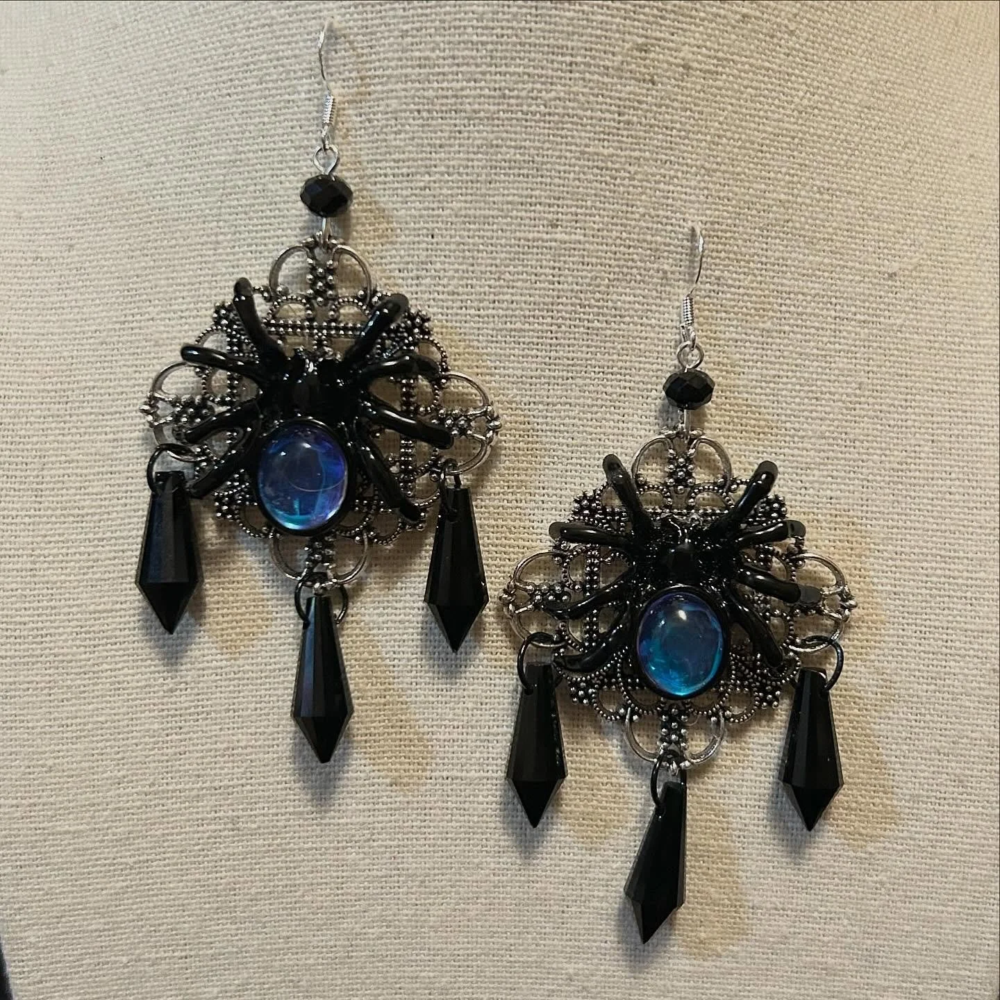 Spider pendants with silver filagree combined with black glass crystals.