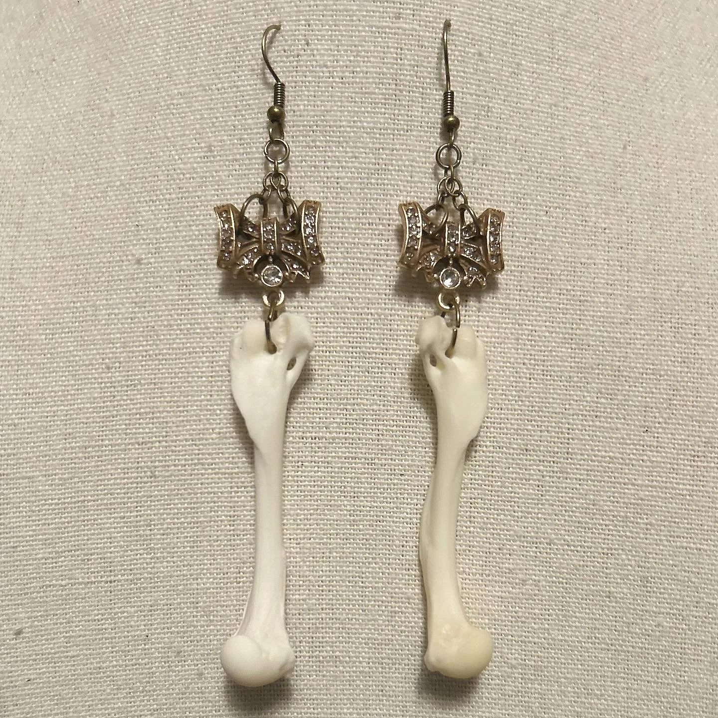 Vintage style gold and rhinestone bows with mink femurs.