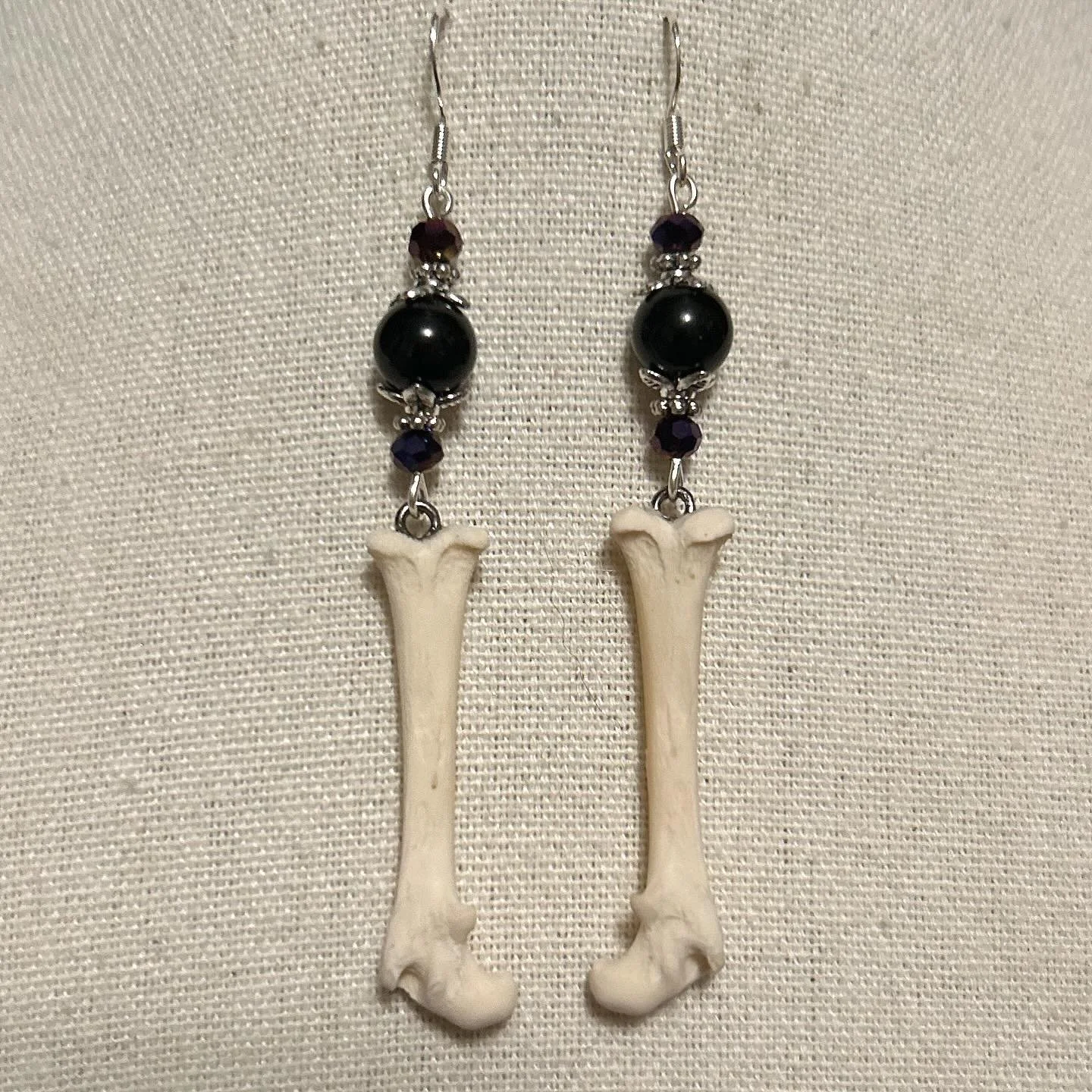 Opossum bones with upcycled black and violet glass beads.