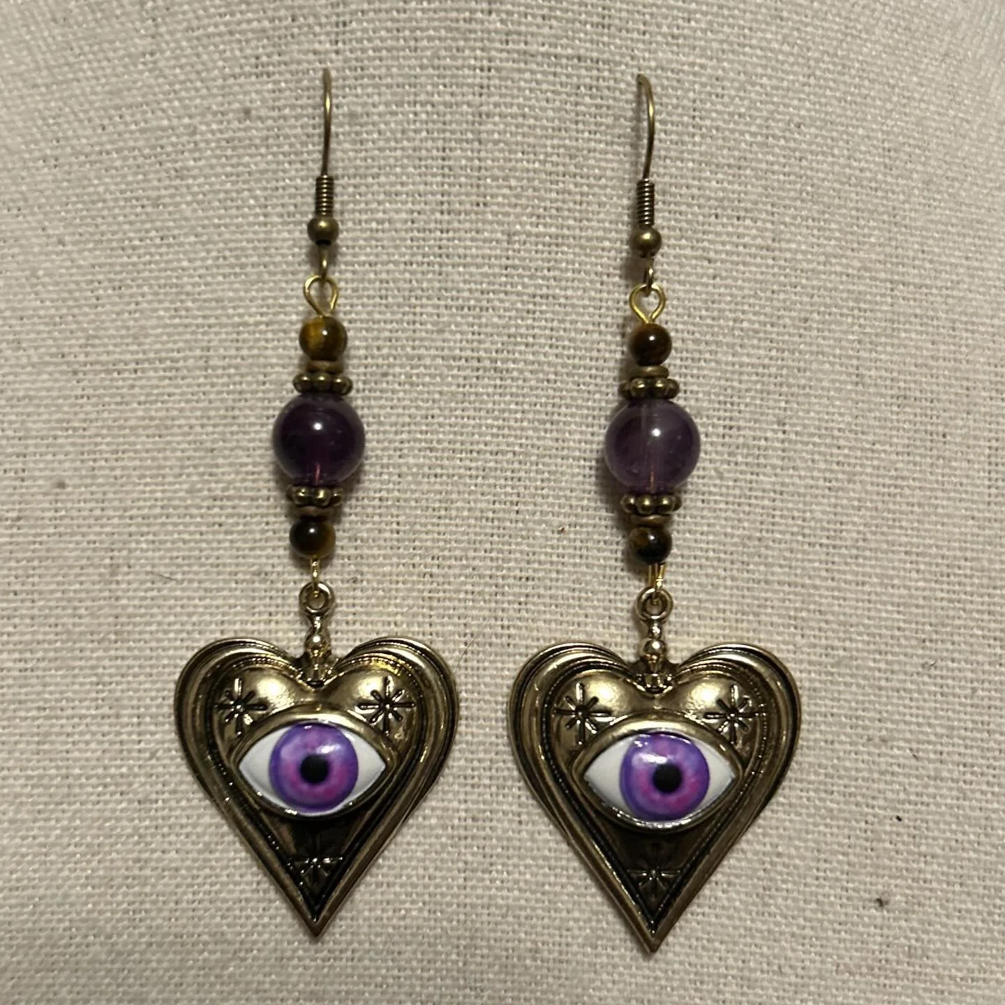 Amethyst and brown tigers eye with gold and brass accents.