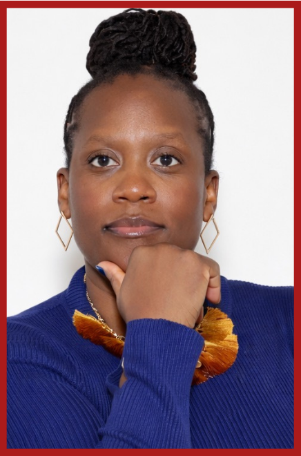 A woman with braided hair styled in an updo, wearing a blue sweater, gold geometric earrings, and a colorful scarf, resting her chin on her hand against a white background with a red border.