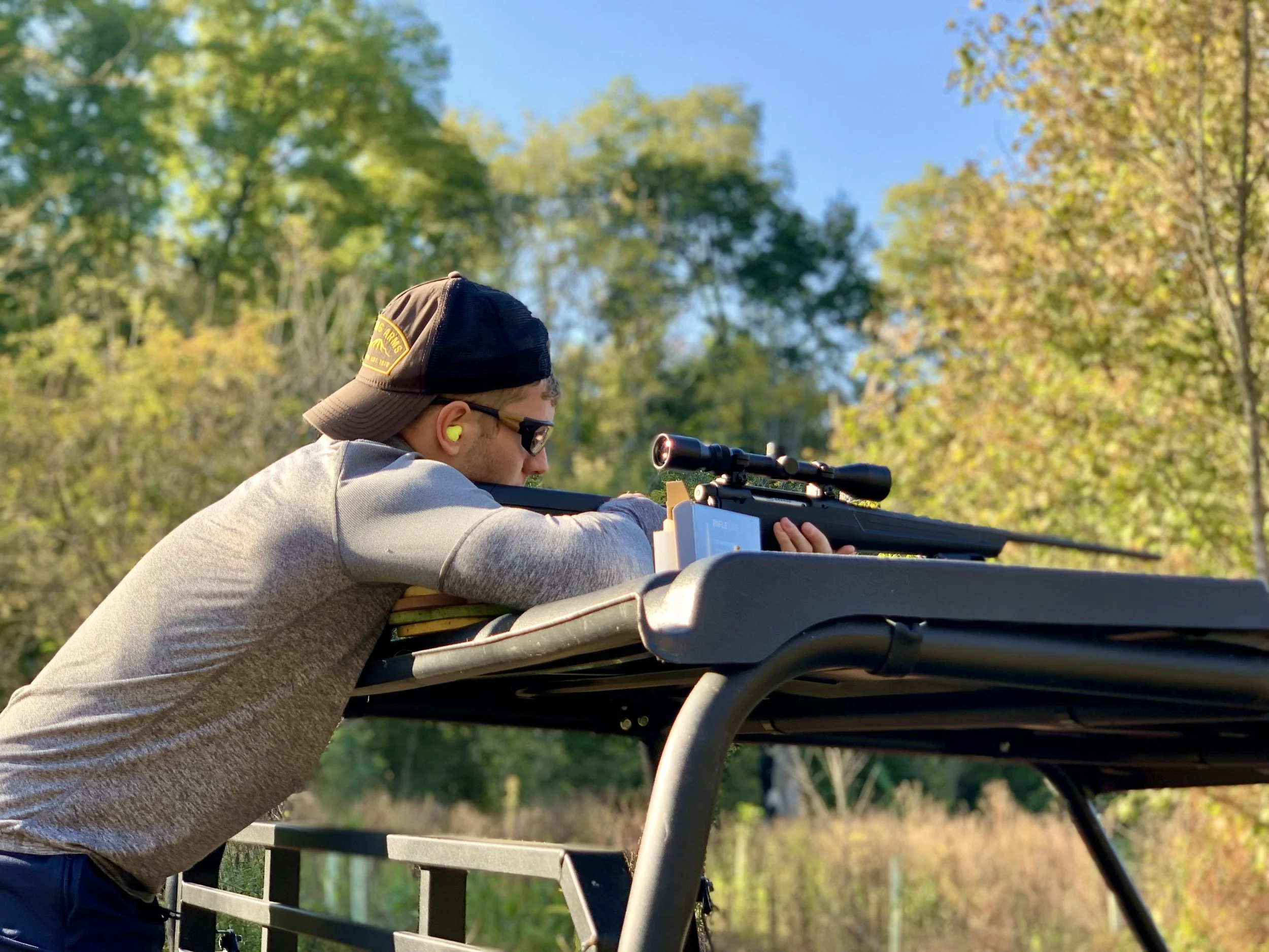 American Conservation Coalition (ACC) President Chris Barnard aims a rifle with a scope during outdoor target practice.