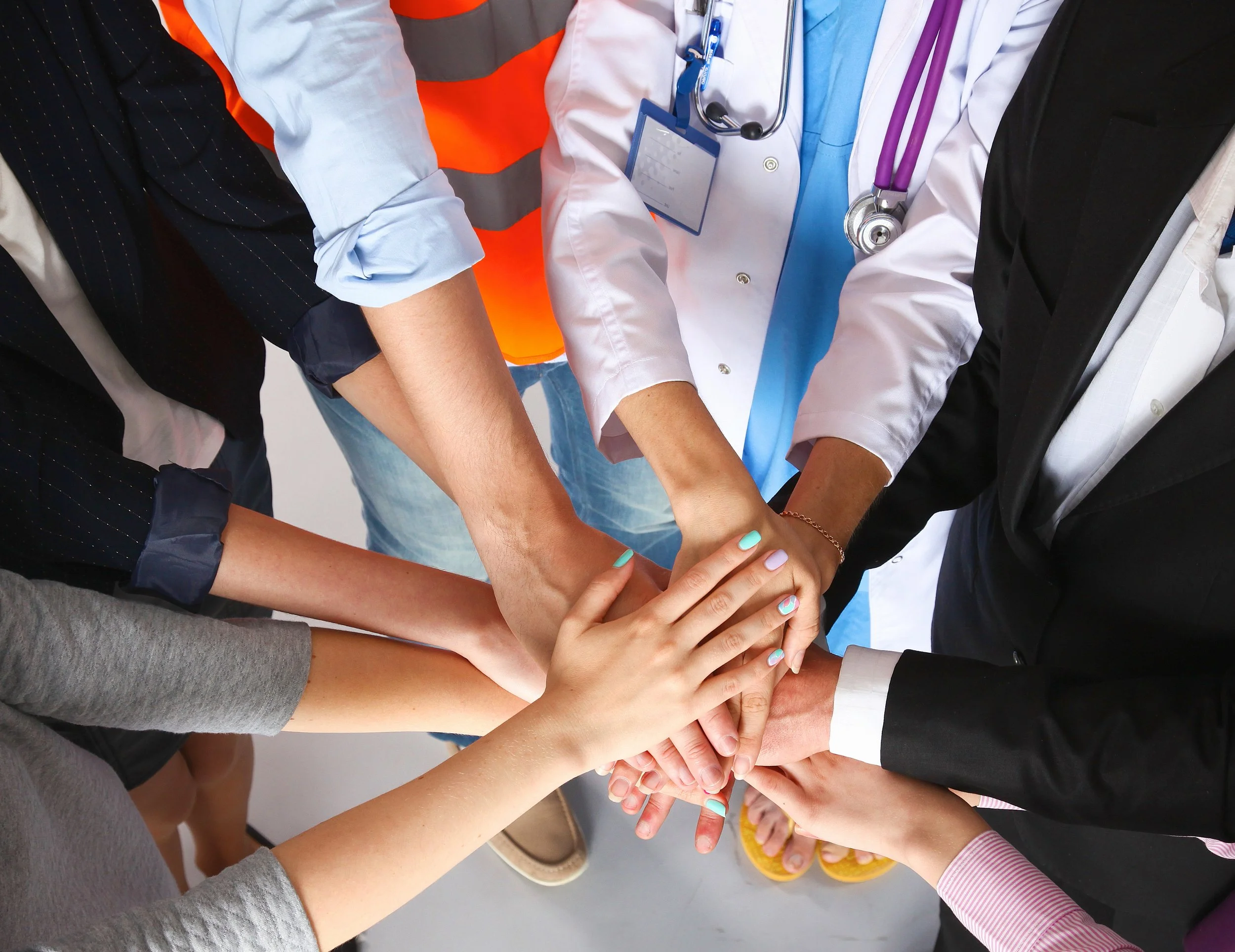 Group of people joining hands, teamwork