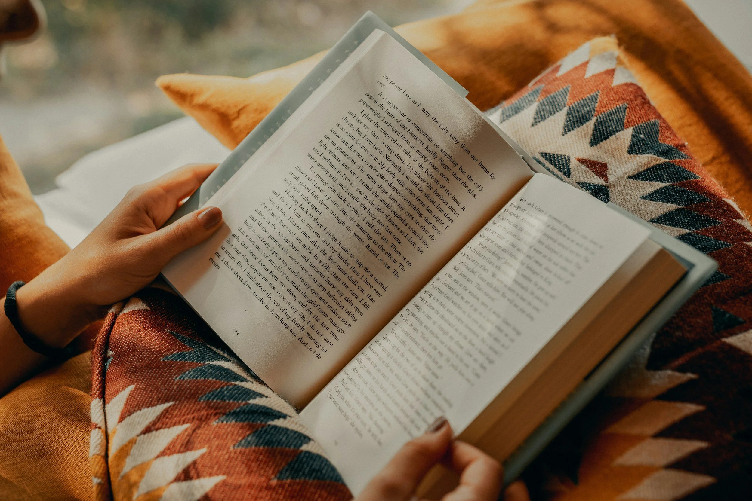 Close-up of a person relaxing with a book, representing the peace of mind that comes with early retirement planning.