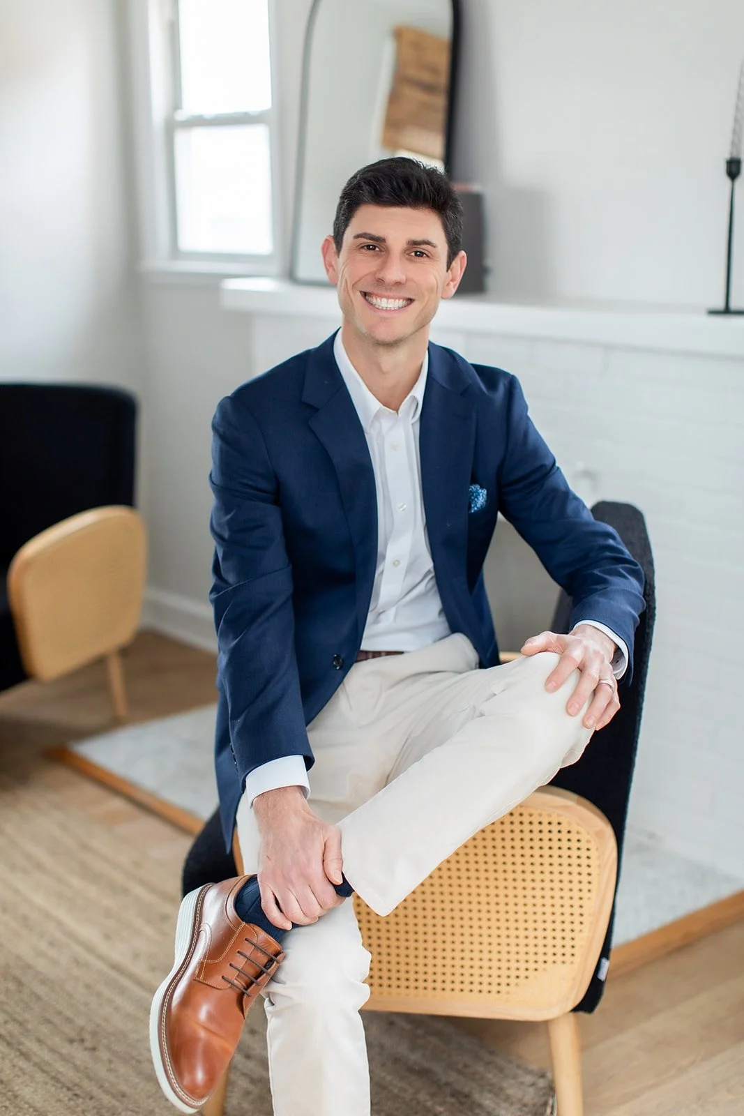 Kent R.S. Groff, CFP®, seated and smiling in a relaxed portrait. A Maryland financial planner who balances professional fiduciary advice with his personal dedication to family and coaching youth sports.