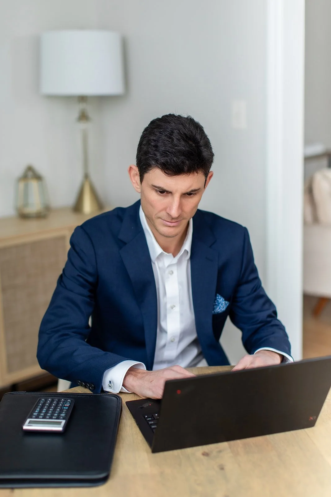 Kent R.S. Groff, CFP®, a second-generation financial planner in Maryland, diligently reviewing a client's wealth strategy on his laptop. Representing the balance of generational wisdom and modern, evidence-based planning.