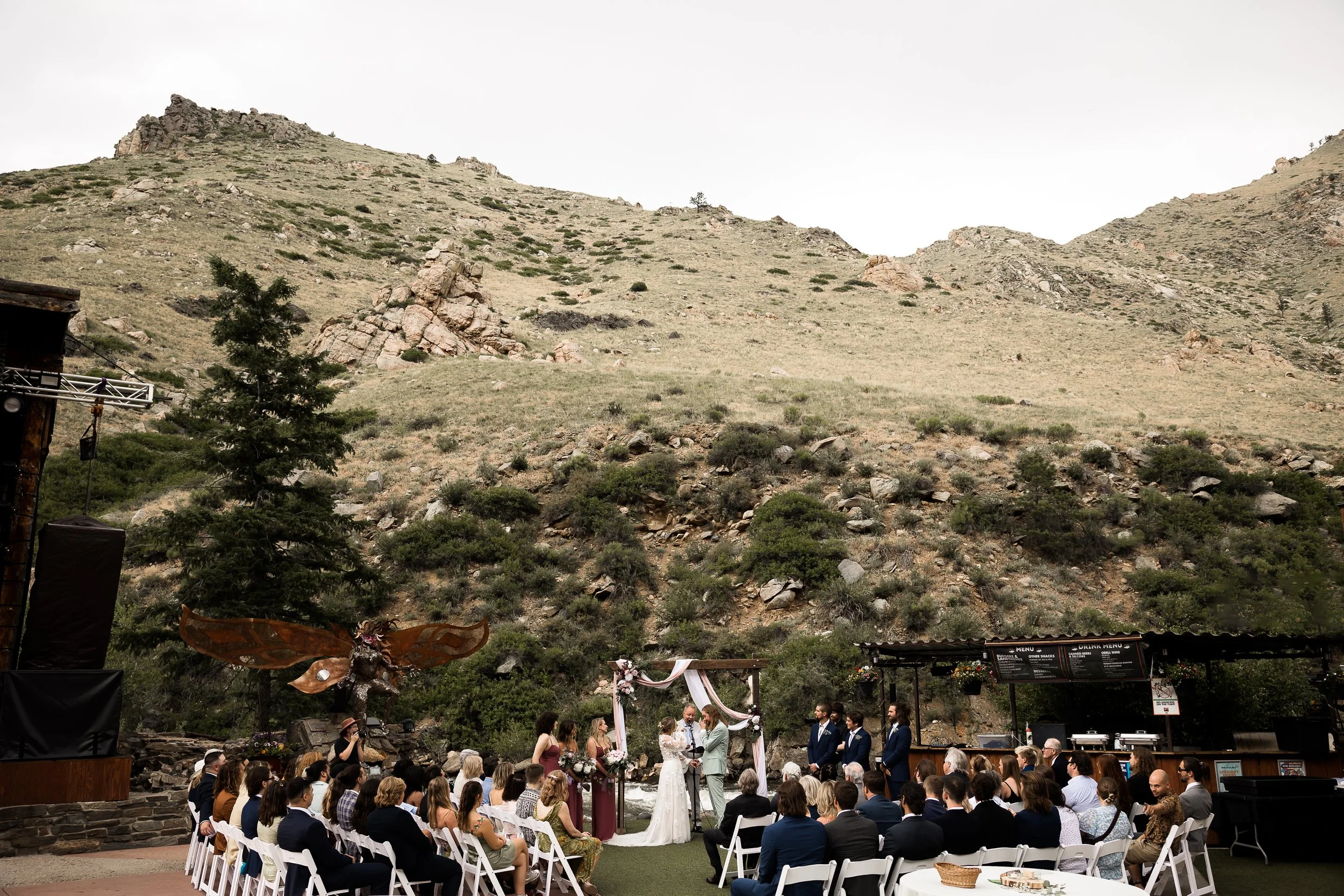 wedding ceremony with a mountain backdrop at the mishawaka ampitheater