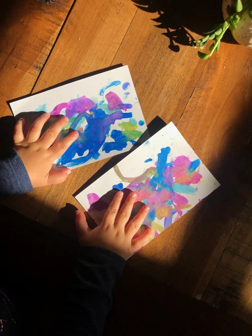 Child using their hands during a colorful art activity