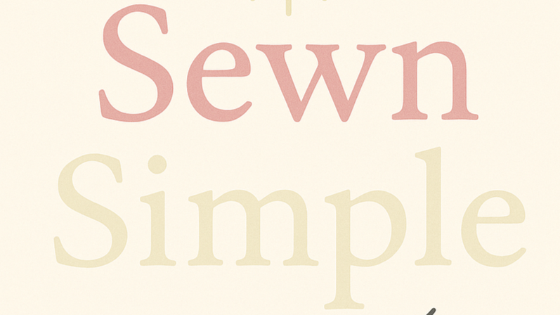 Close-up of a sign or poster with the words 'Sewn' and 'Simple' in large, pastel-colored letters.
