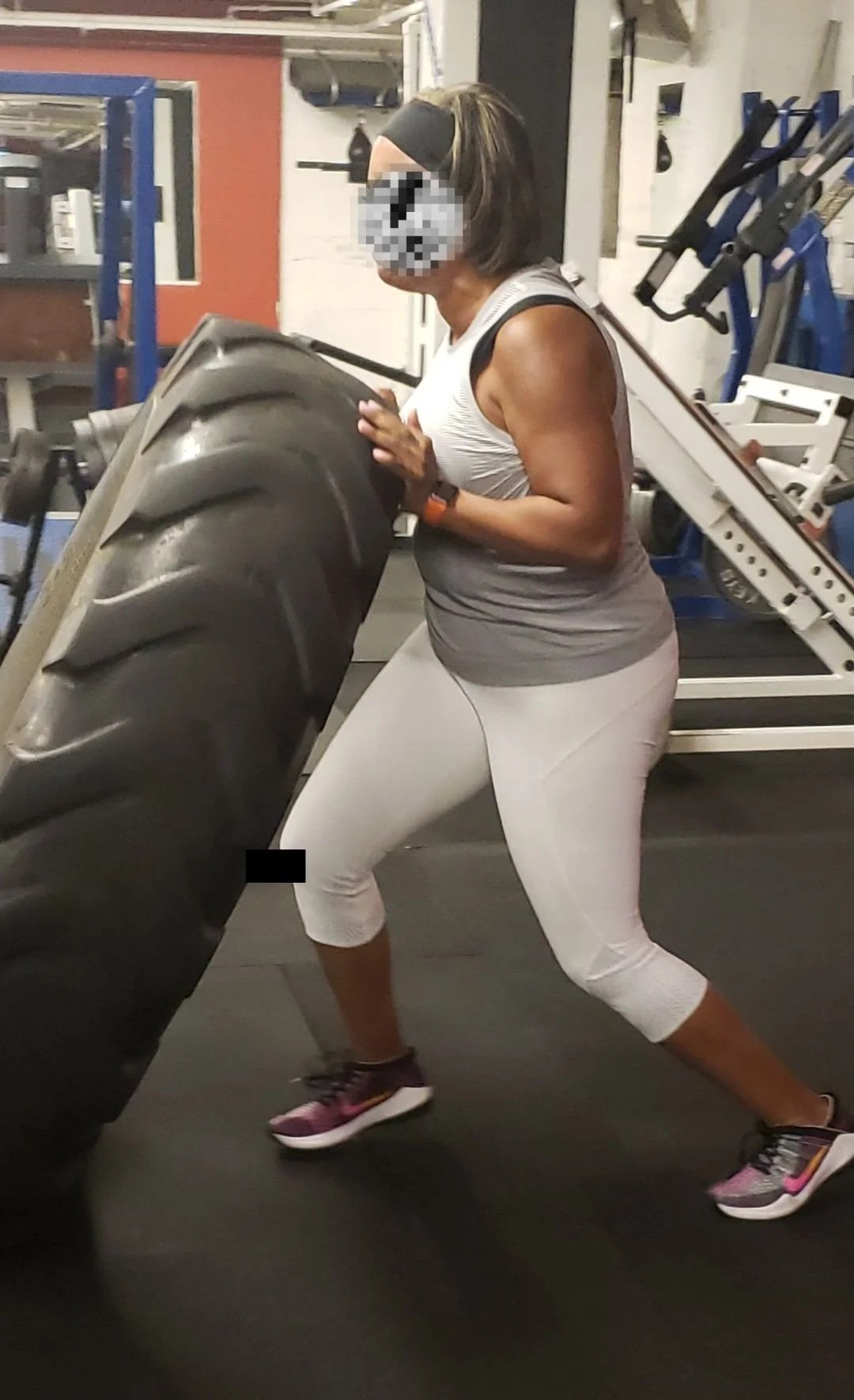 Seattle personal trainer client showcasing tire flip as part of a strength and mobility routine.