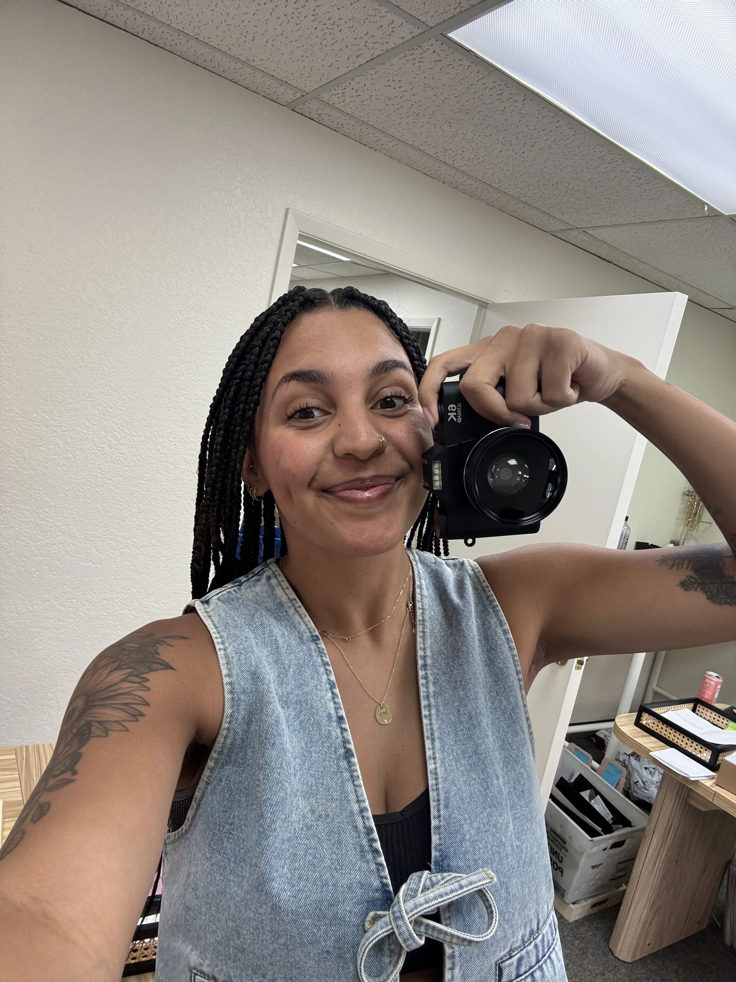 Girl smiling taking a selfie with a camera