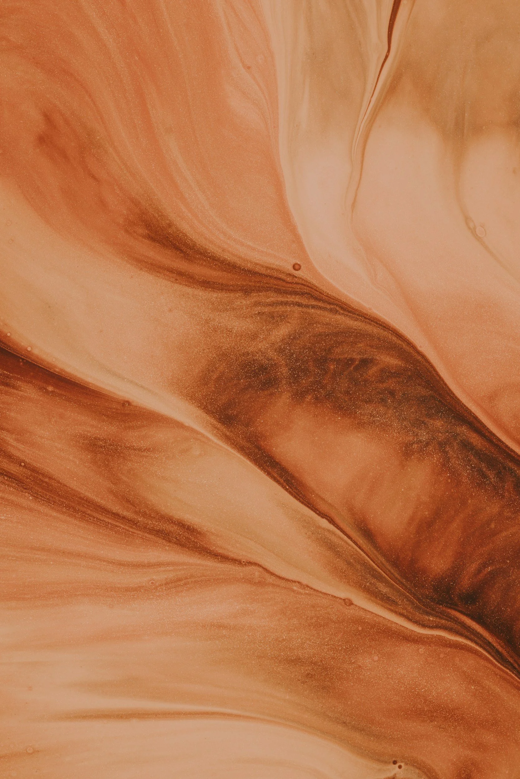 Abstract swirl of brown, beige, and cream colors resembling a marbled pattern.