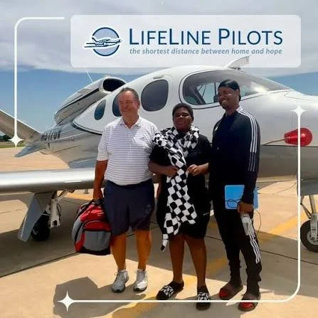 Three people standing in front of a private jet under a Lifeline Pilots banner, with the slogan 'the shortest distance between home and hope.'
