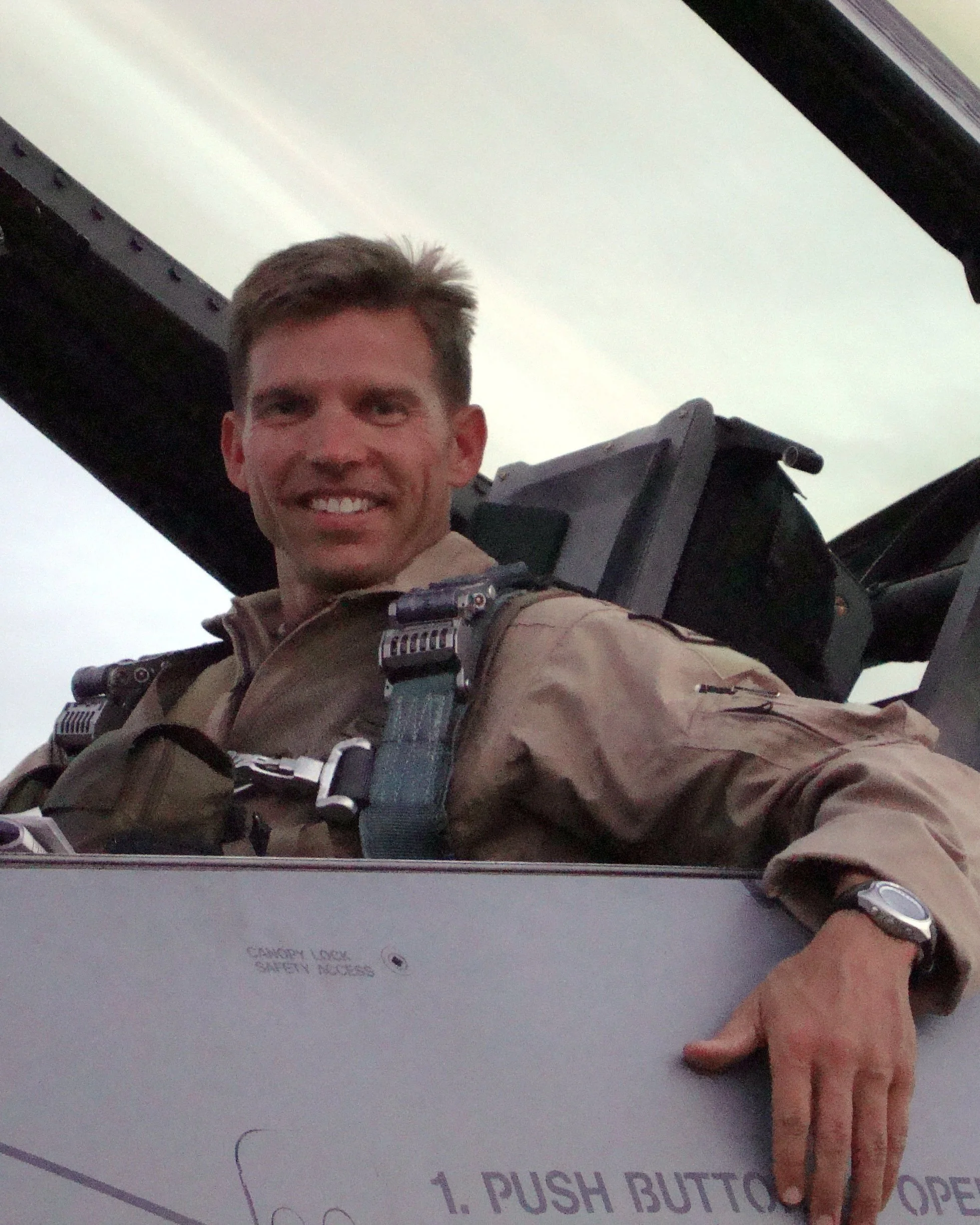 Fighter Pilot James Reeman strapped into the cockput of an F-16 Fighting Falcon fighter jet.