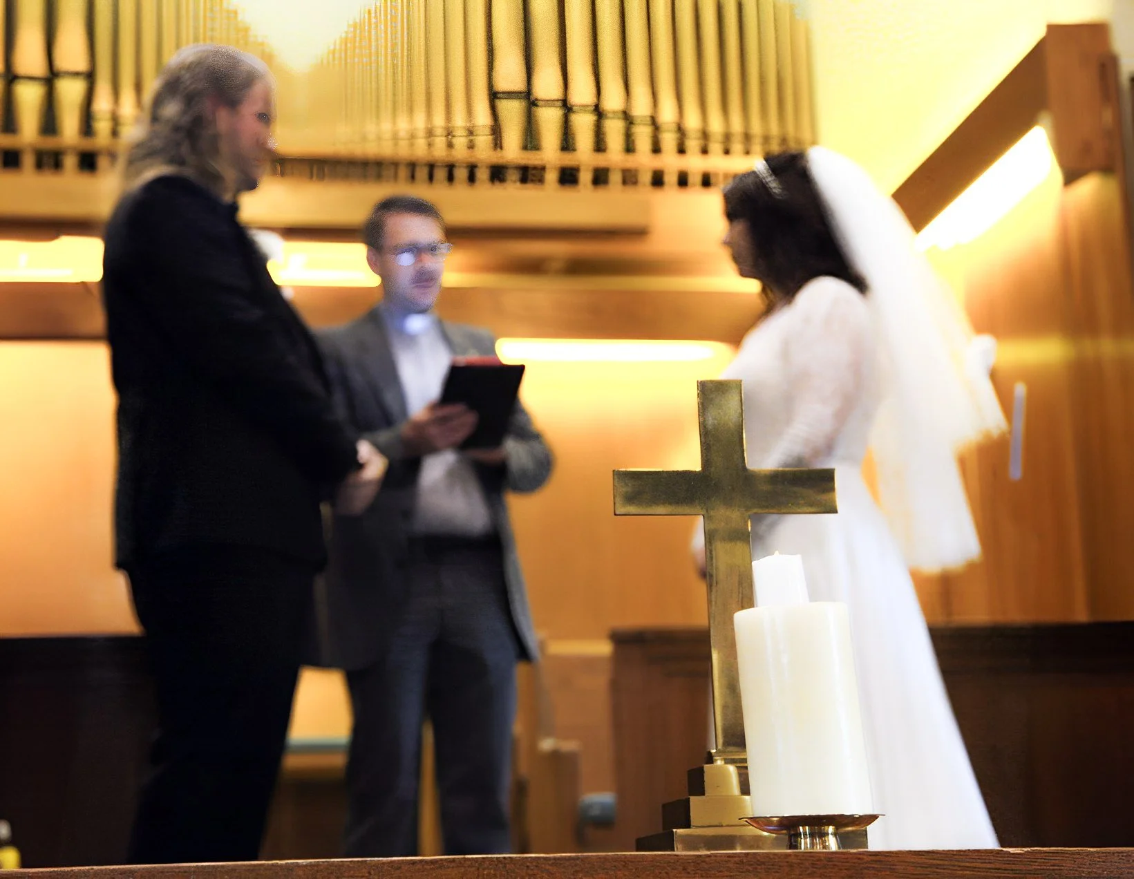 Wedding ceremony with a cross in the foreground