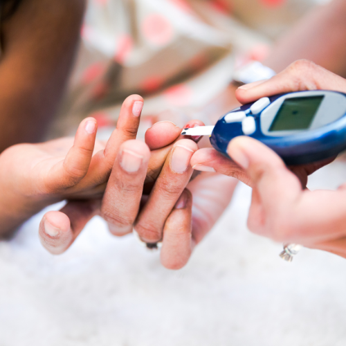 Person using a blood glucose meter to check blood sugar levels.
