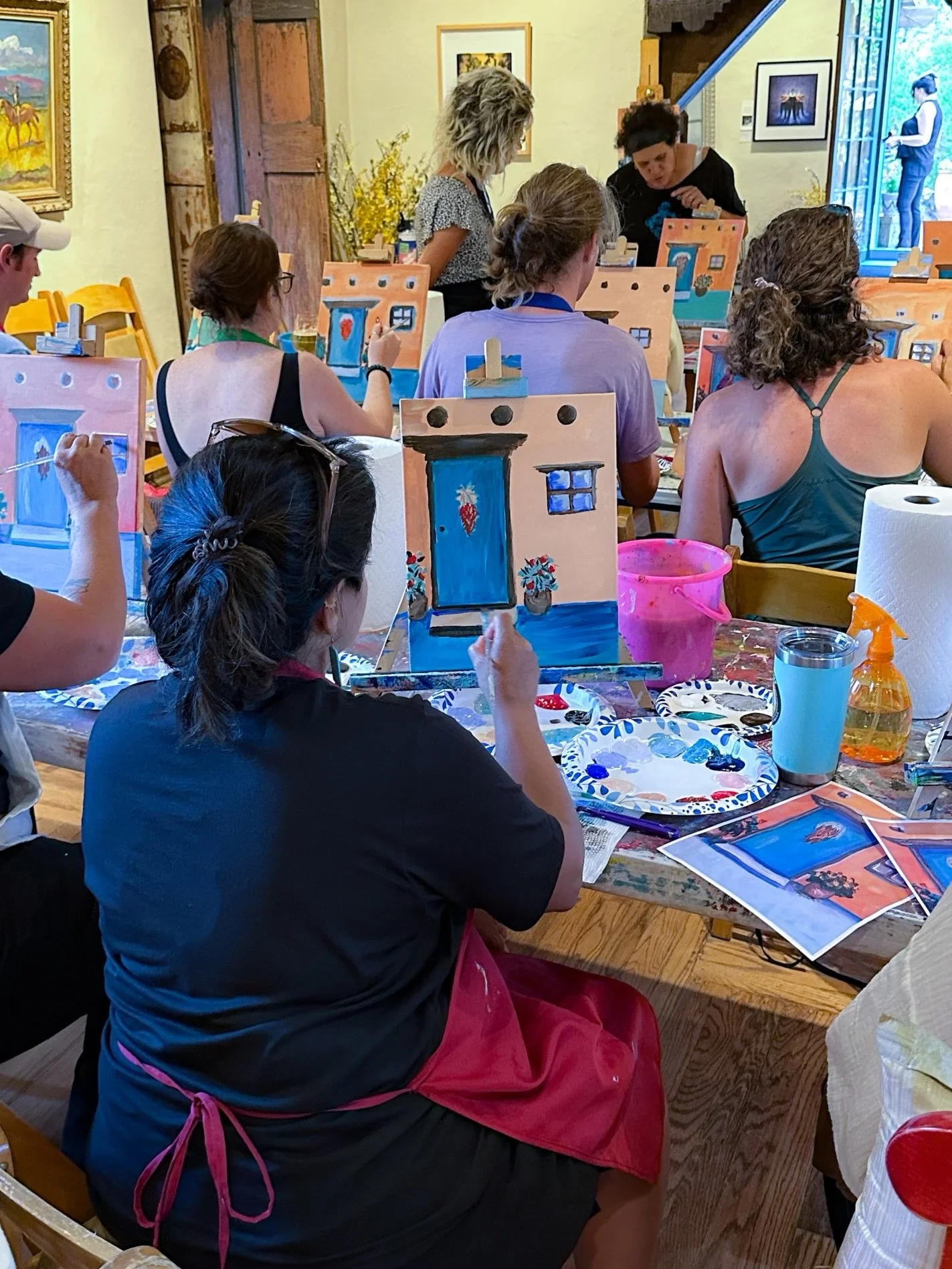 Creative wellness painting workshop for mission-driven organizations in Nevada – painting floral door designs facilitated by ALIGN Agency