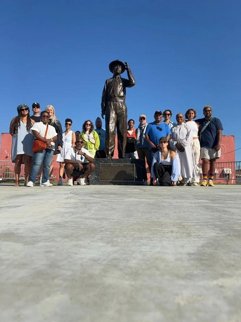 ommunity engagement event for mission-driven organizations in Nevada – participants standing behind bronze statue of a boy outdoors, facilitated by ALIGN Agency