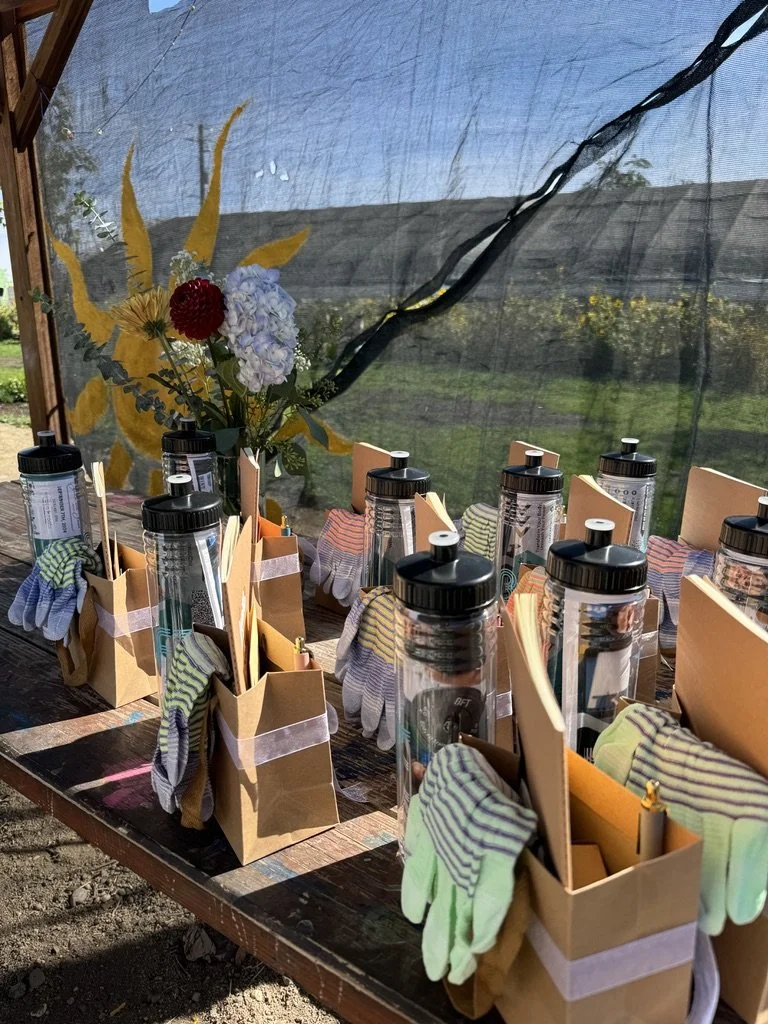Outdoor community or nonprofit workshop setup in Nevada – wellness and retreat supplies with tools, gloves, and water bottles prepared by ALIGN Agency