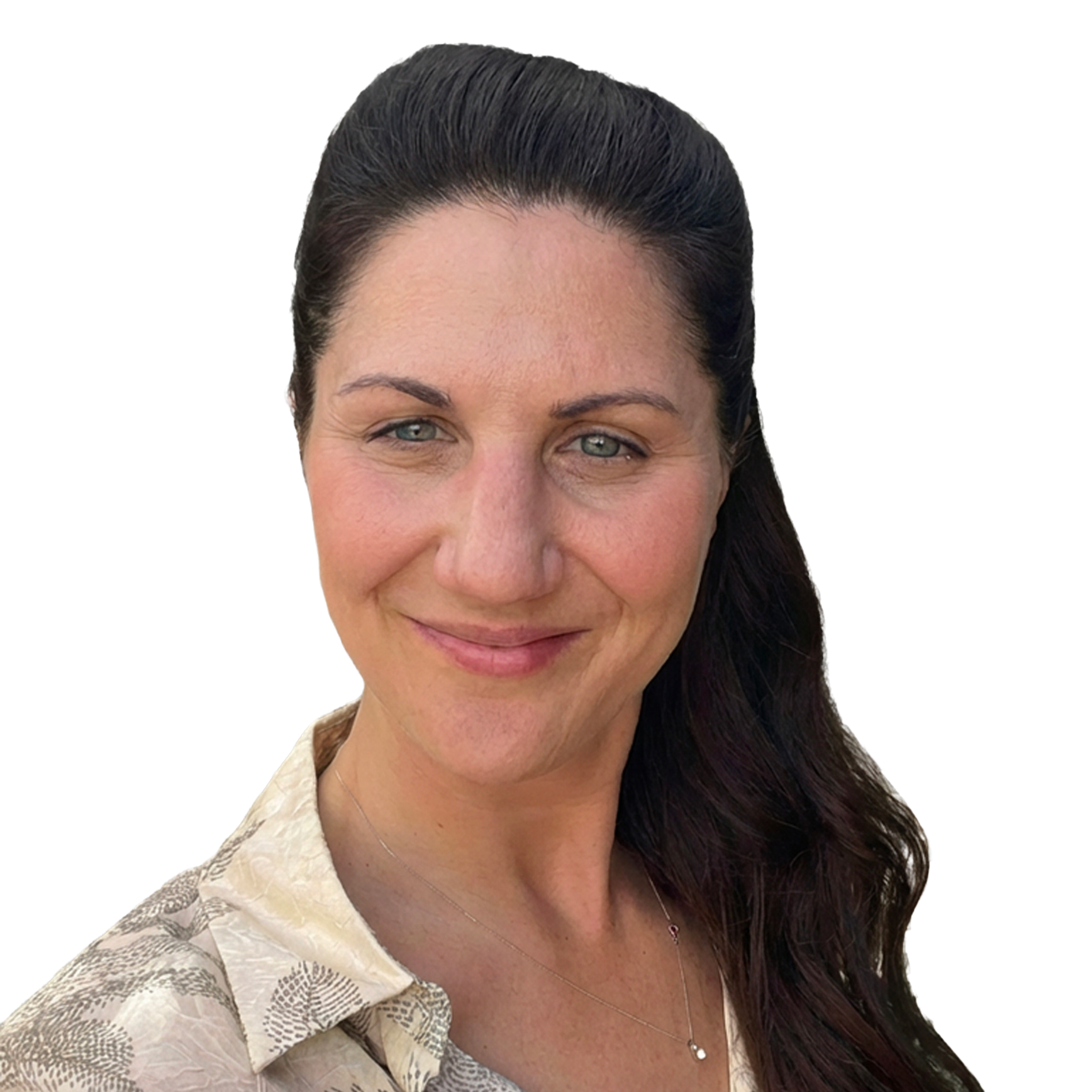 A woman with dark brown hair in a ponytail, blue eyes, smiling, wearing a beige patterned shirt and a delicate necklace.