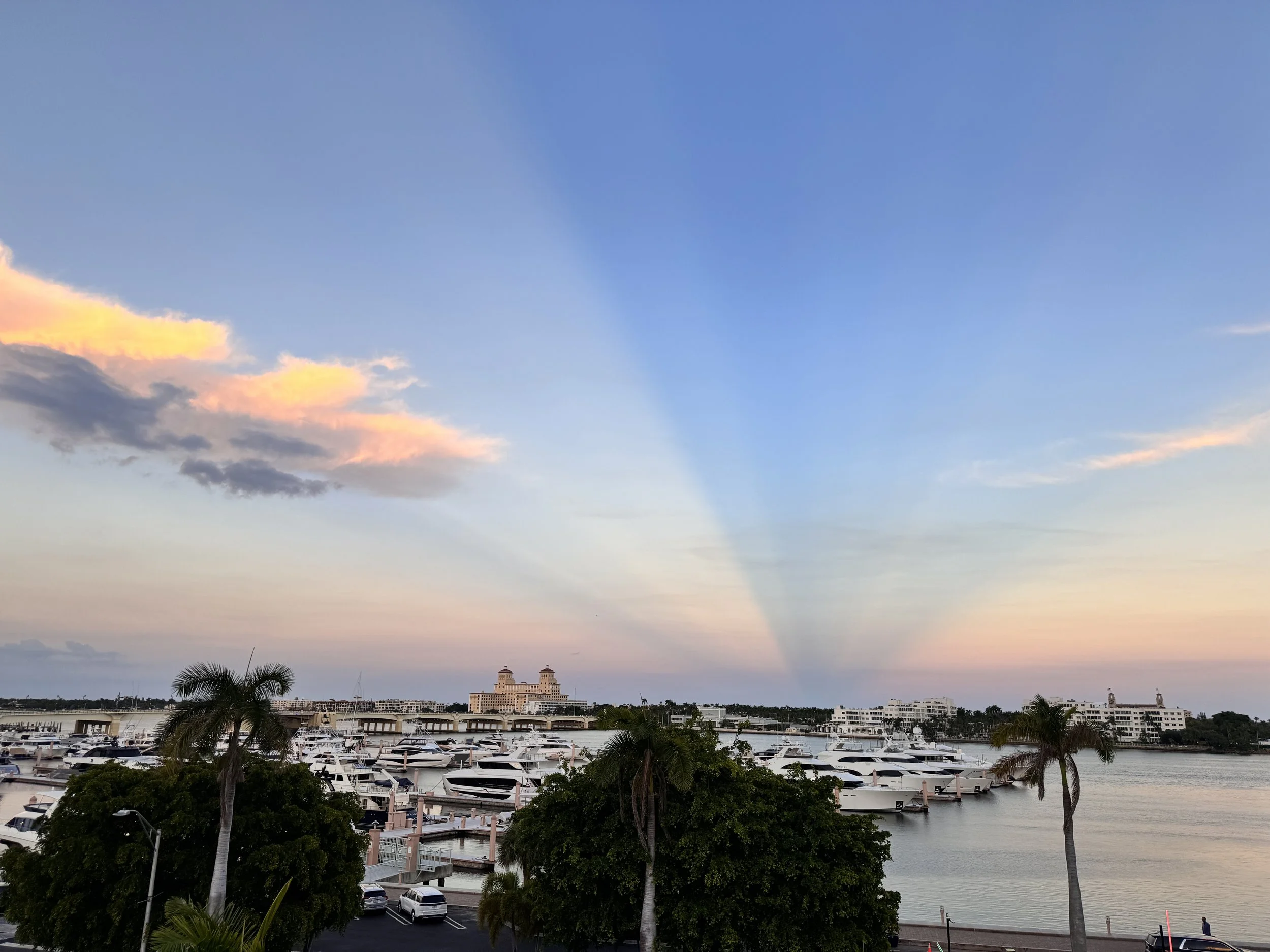 Waterfront marina with yachts and palm trees at sunset in Palm Beach Florida – concierge medicine service area