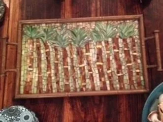 A wooden tray filled with vertically arranged bamboo.