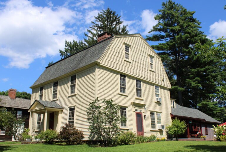 Historic yellow colonial house on Old Main Street in Deerfield, Massachusetts, standing on the site of the earlier Nims family home destroyed in the 1704 raid on Deerfield.