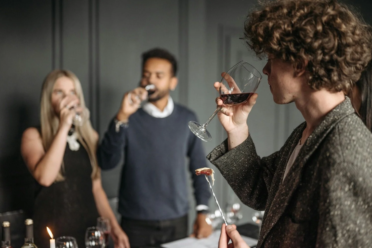 several people tasting wine