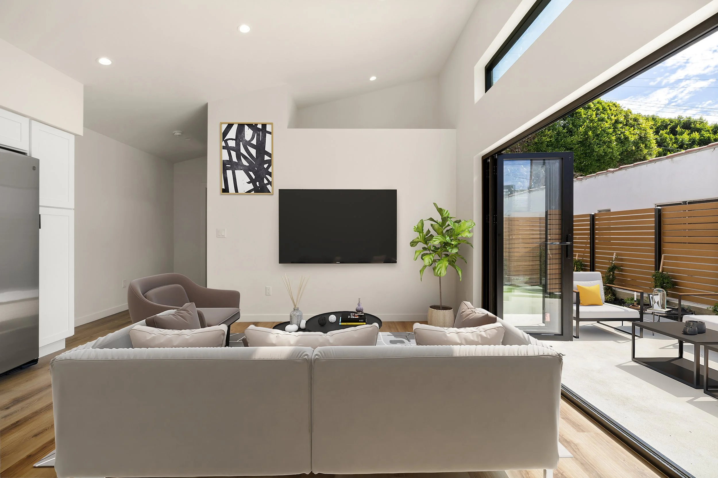 Bright and airy living room with indoor outdoor entertainment space in Southern California. Housing development services by Casitas Development