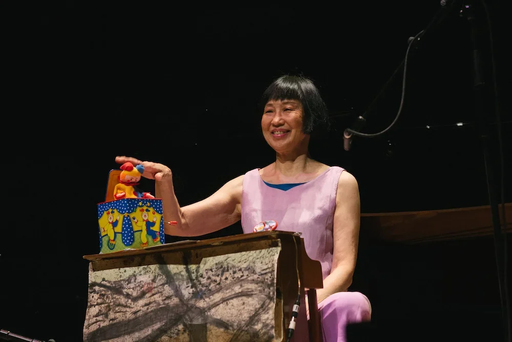 Performer on stage smiling at the audience