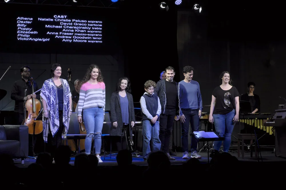 9 performers receiving applause on stage