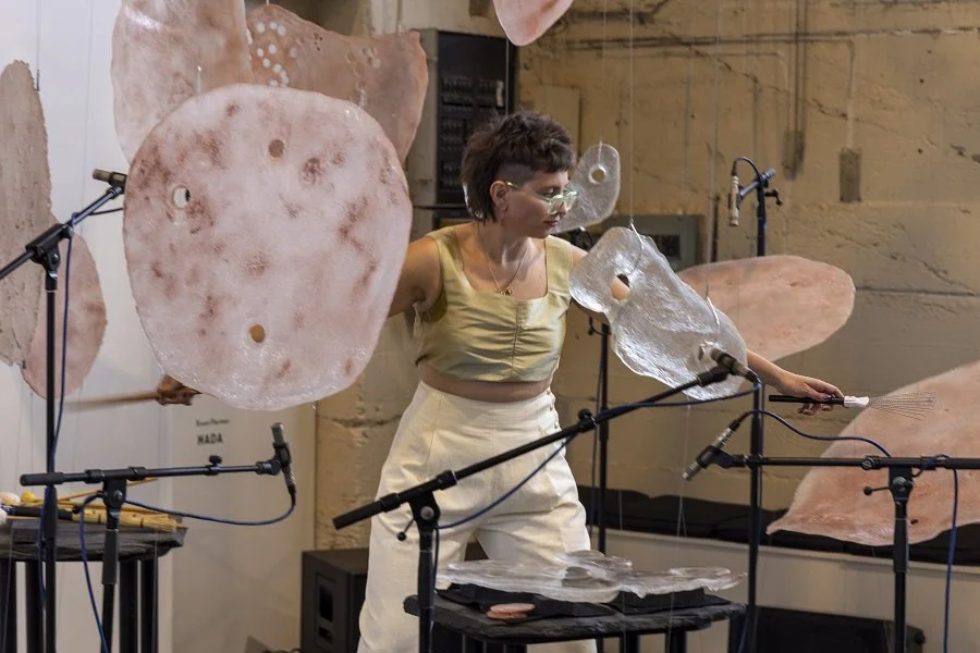 Woman playing large plastic objects as percussion