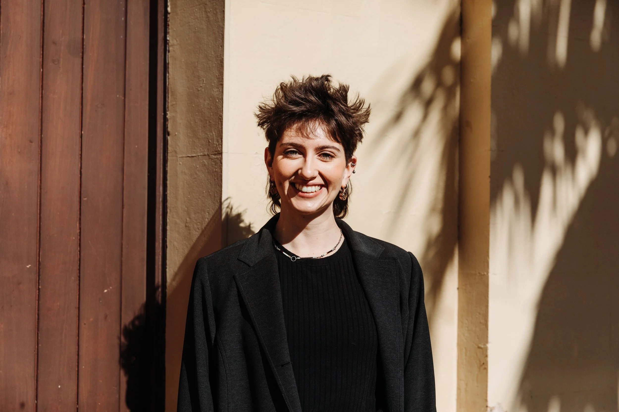 Woman standing outside smiling at camera