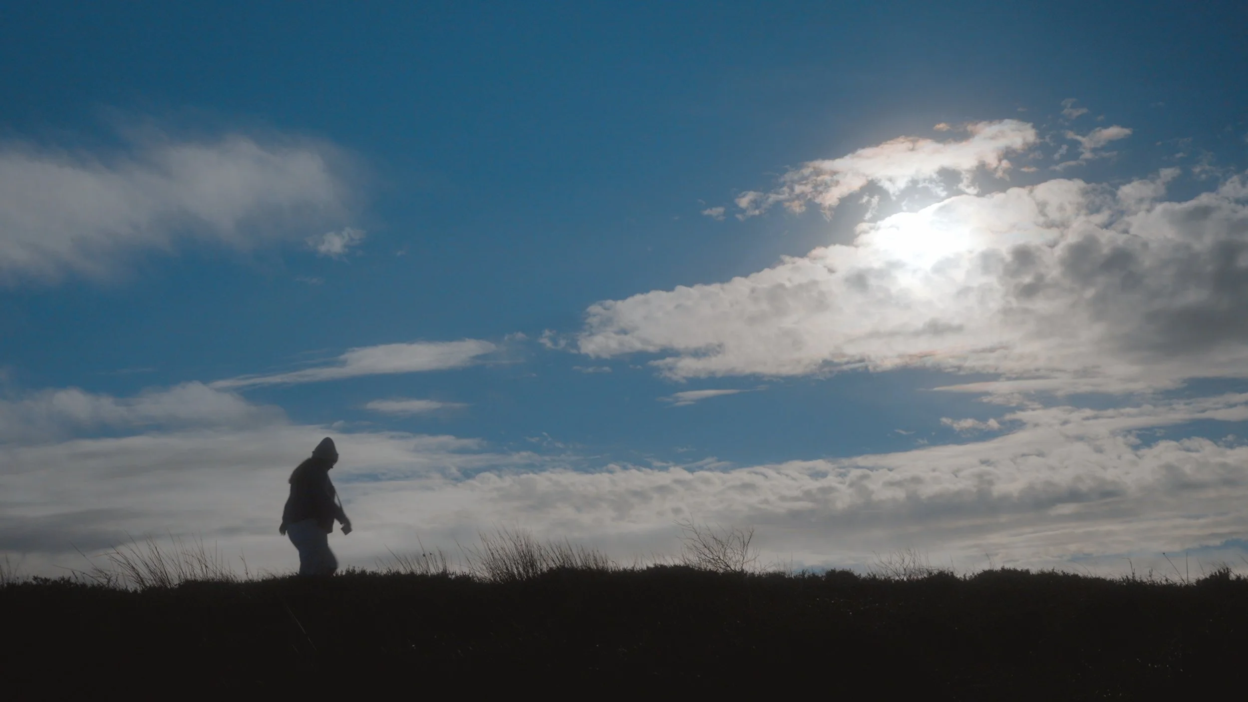  By having my actor silhouetted and surrounded by the negative space of the sky, this shot, and the next shot, represent a journey from darkness heading towards the light. 