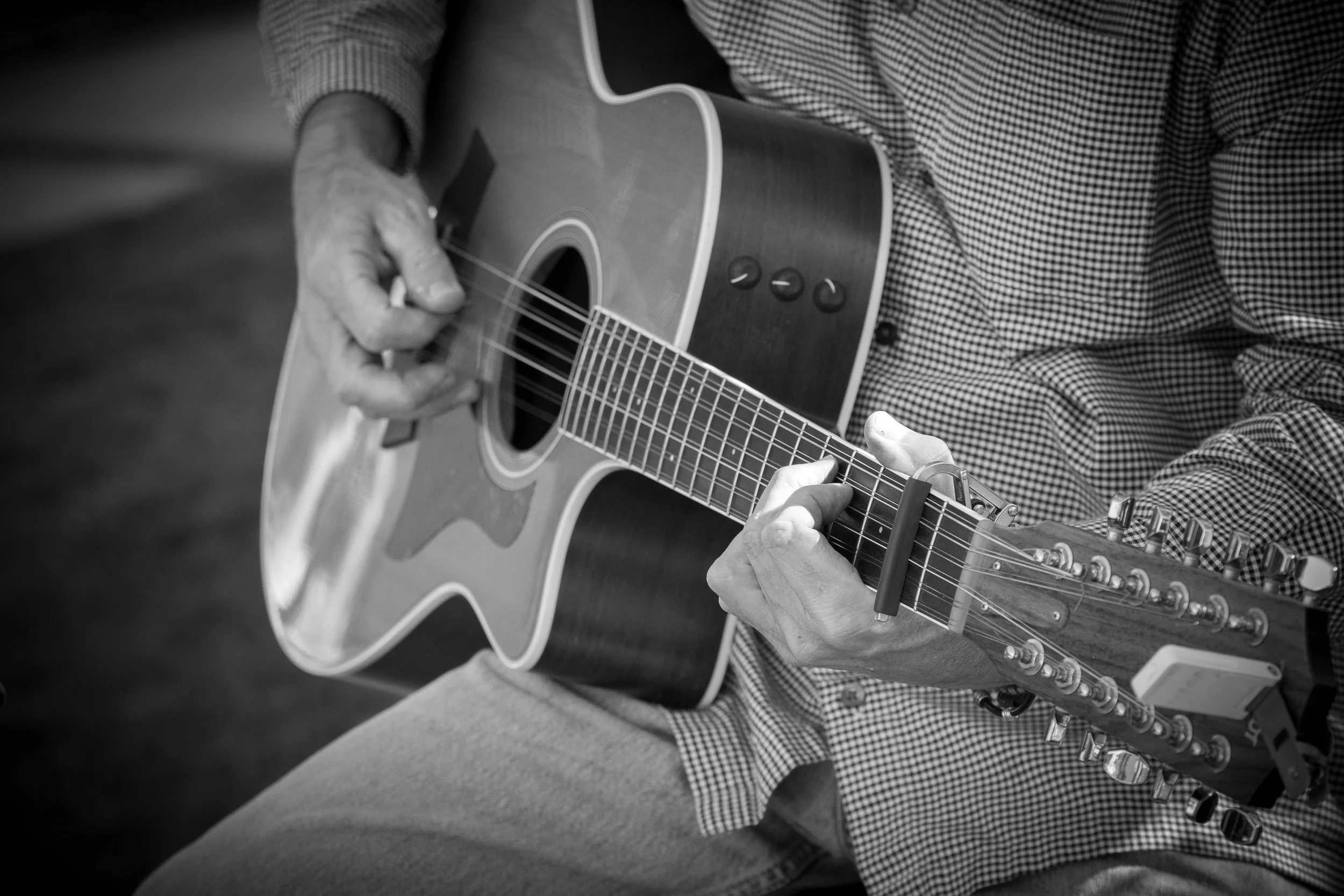 A close up of Eric's hand playing guitar