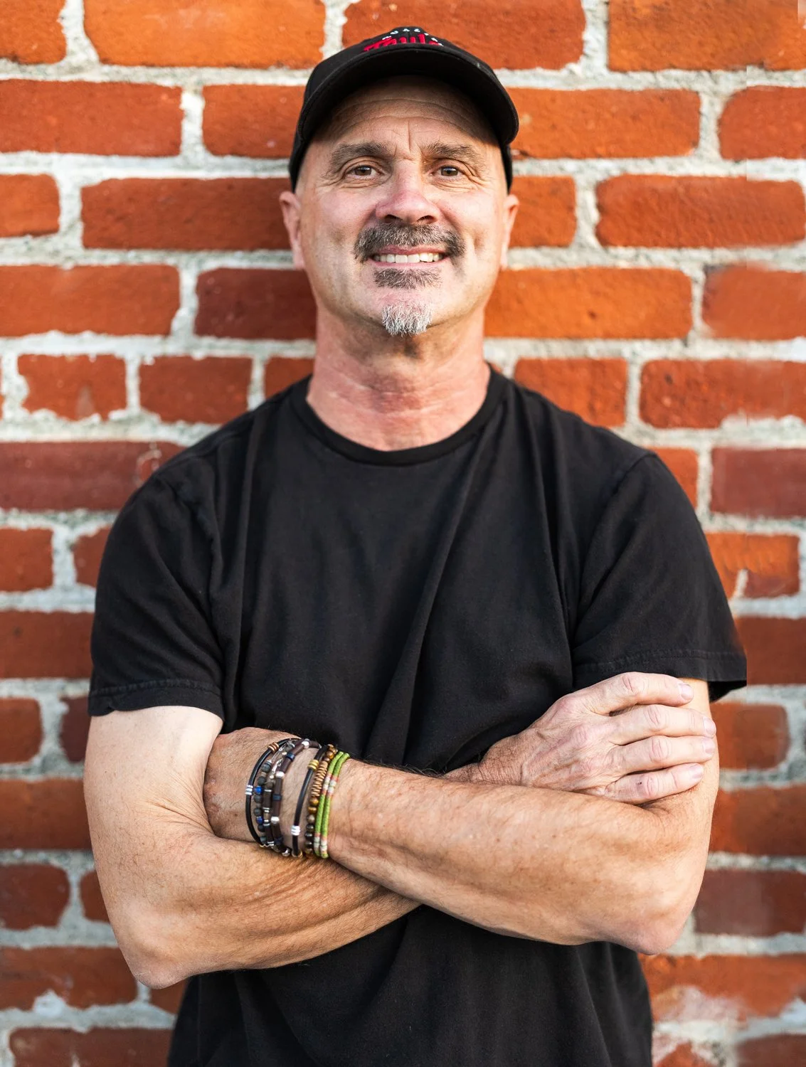 eric standing in front of a red brick wall