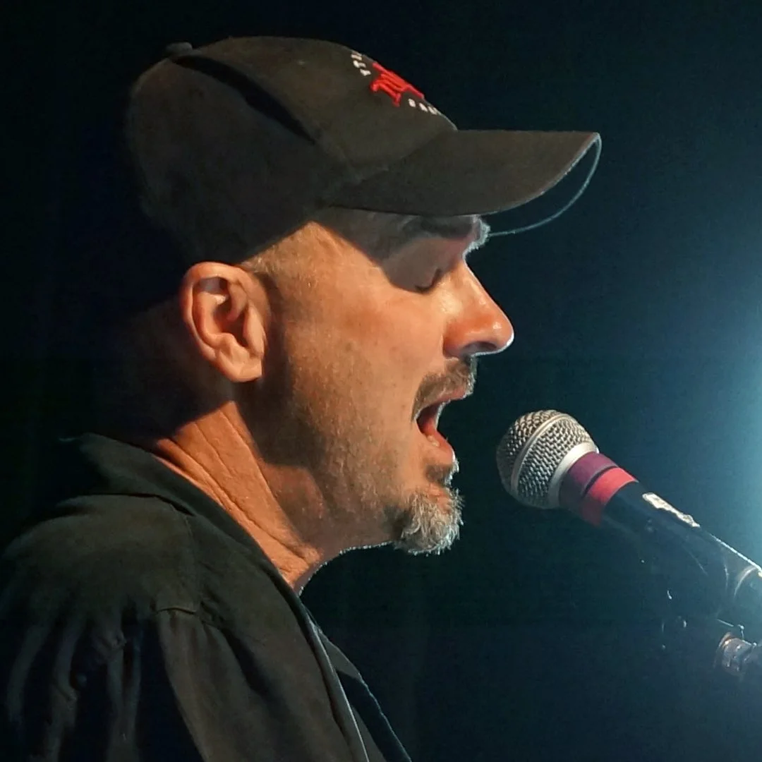 Eric Zobel singing into a microphone