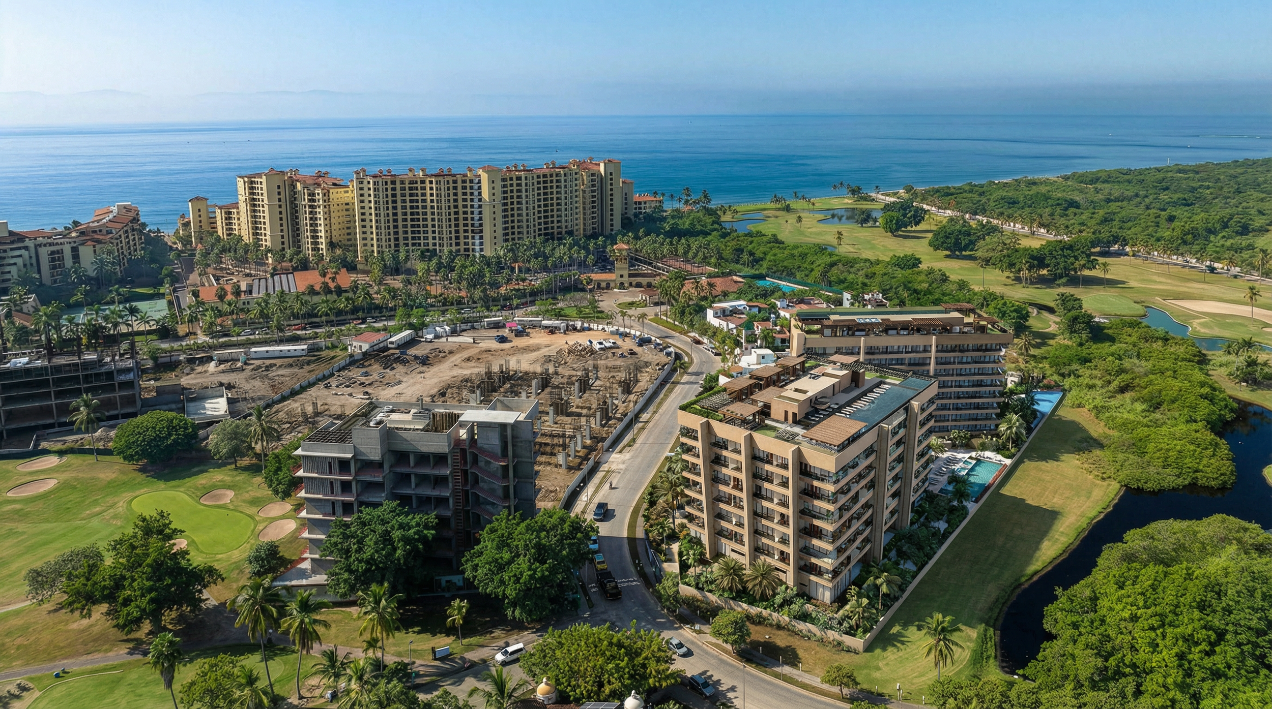 Aerial view of a coastal resort with high-rise buildings, a golf course, lush greenery, and the ocean in the background.