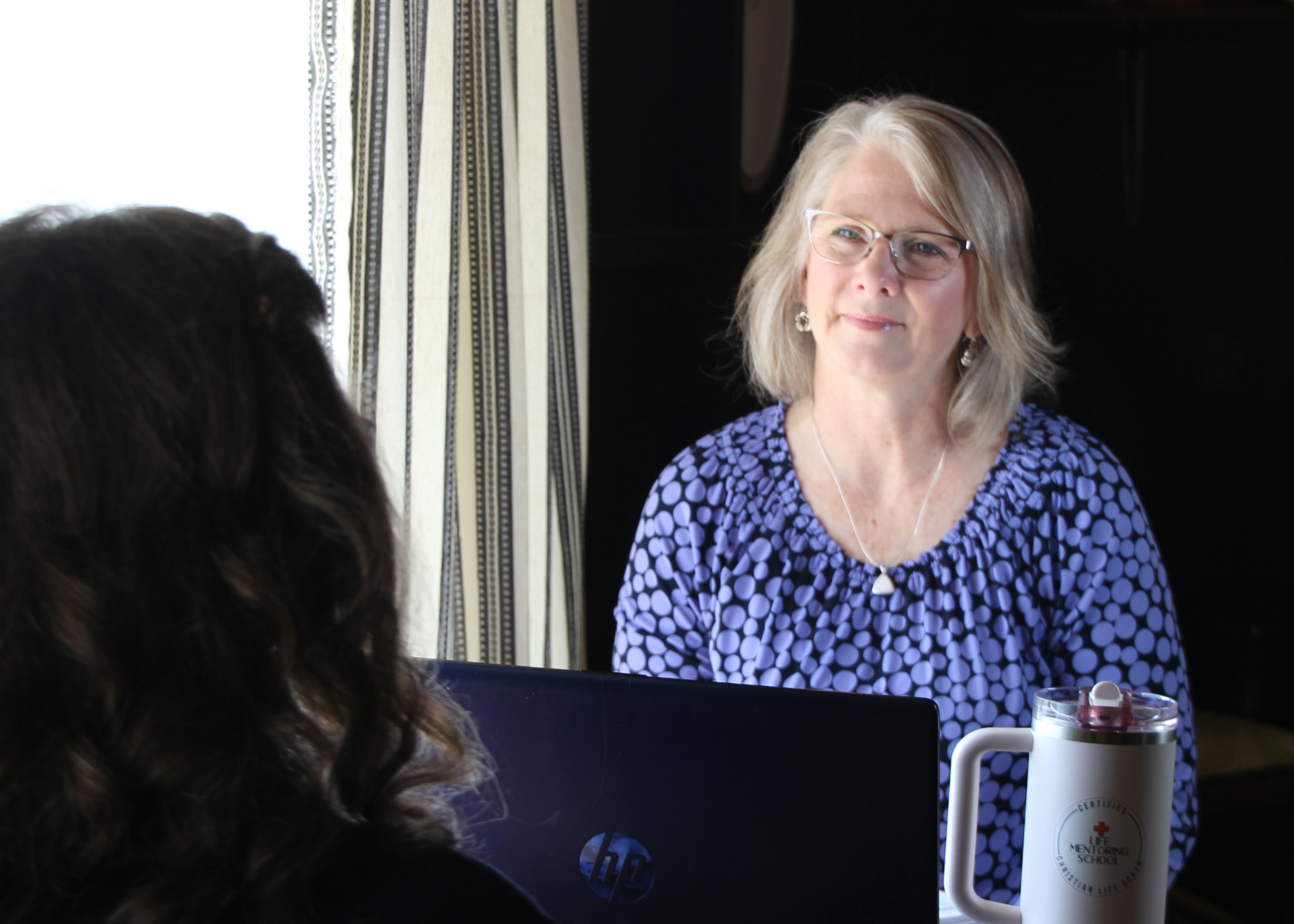 Woman looking at another woman in a coaching session in Mountain View, MO