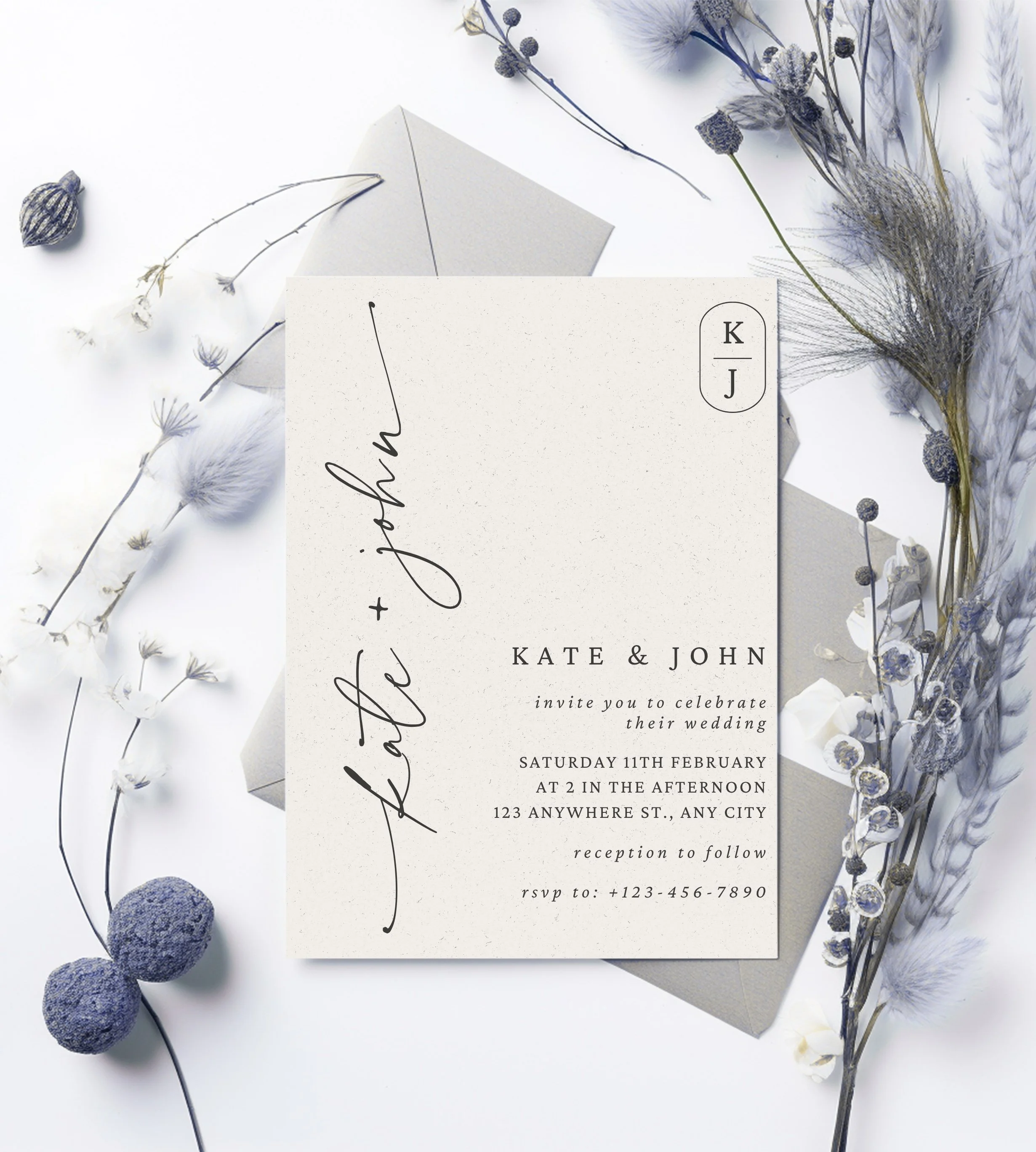 Wedding invitation card with navy and white floral decorations and a white envelope.