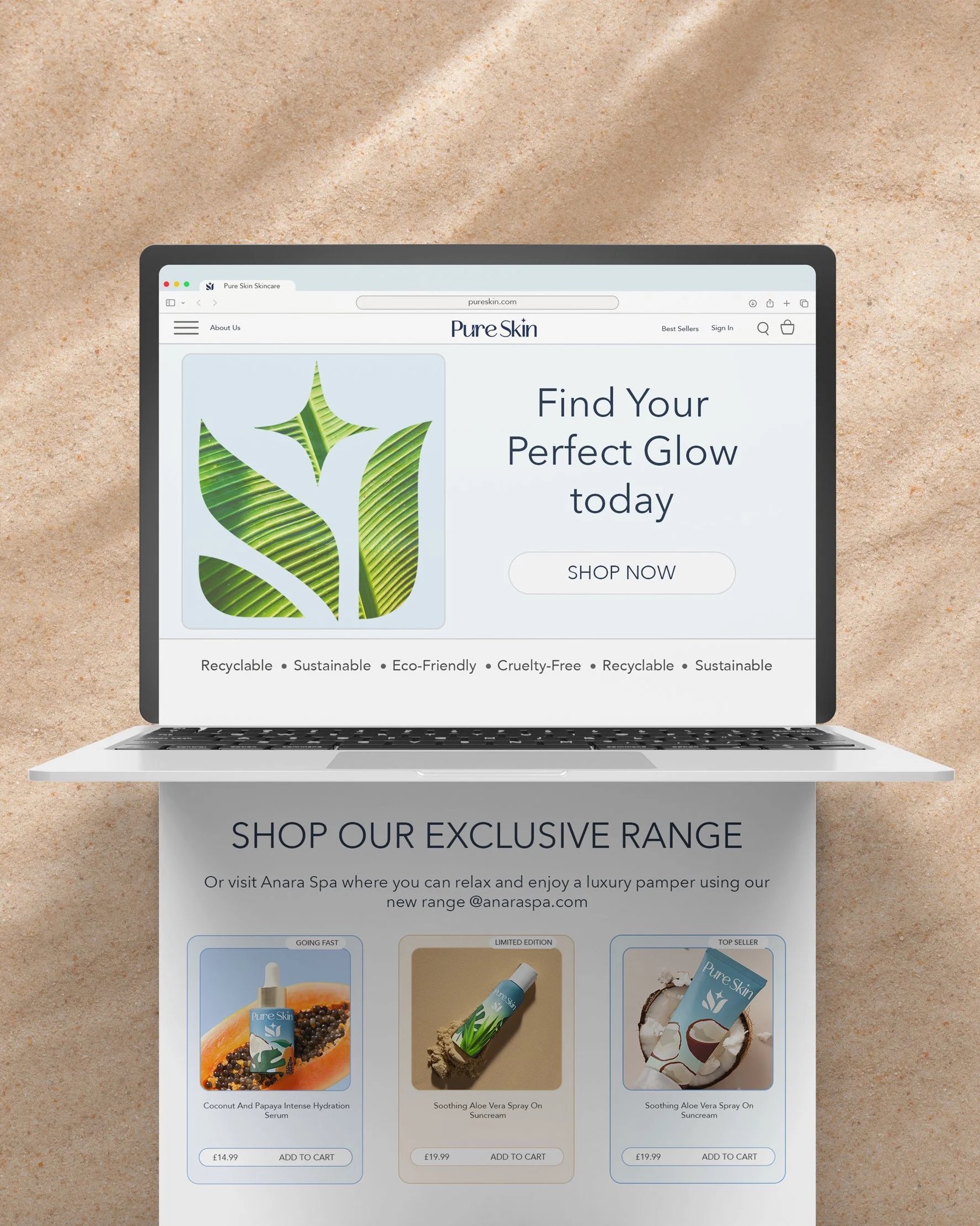 Laptop displaying a skincare website on a sandy surface, featuring products like aloe vera spray and coconut serum.