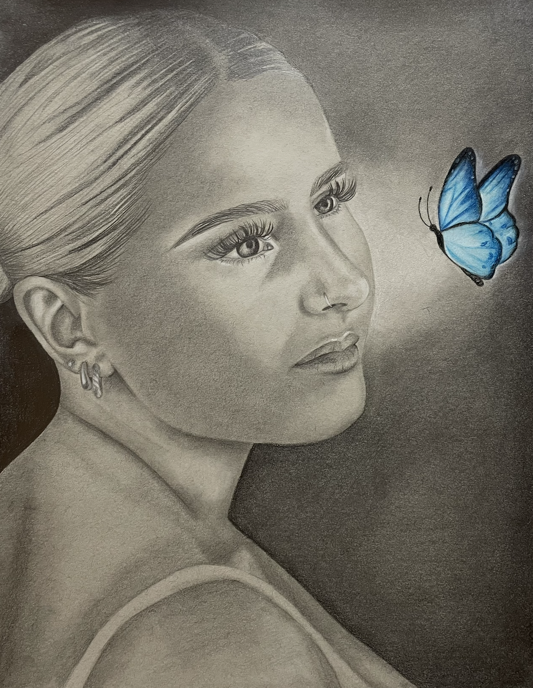 A grayscale pencil drawing of a woman with a butterfly near her face, colored in blue, against a dark background.