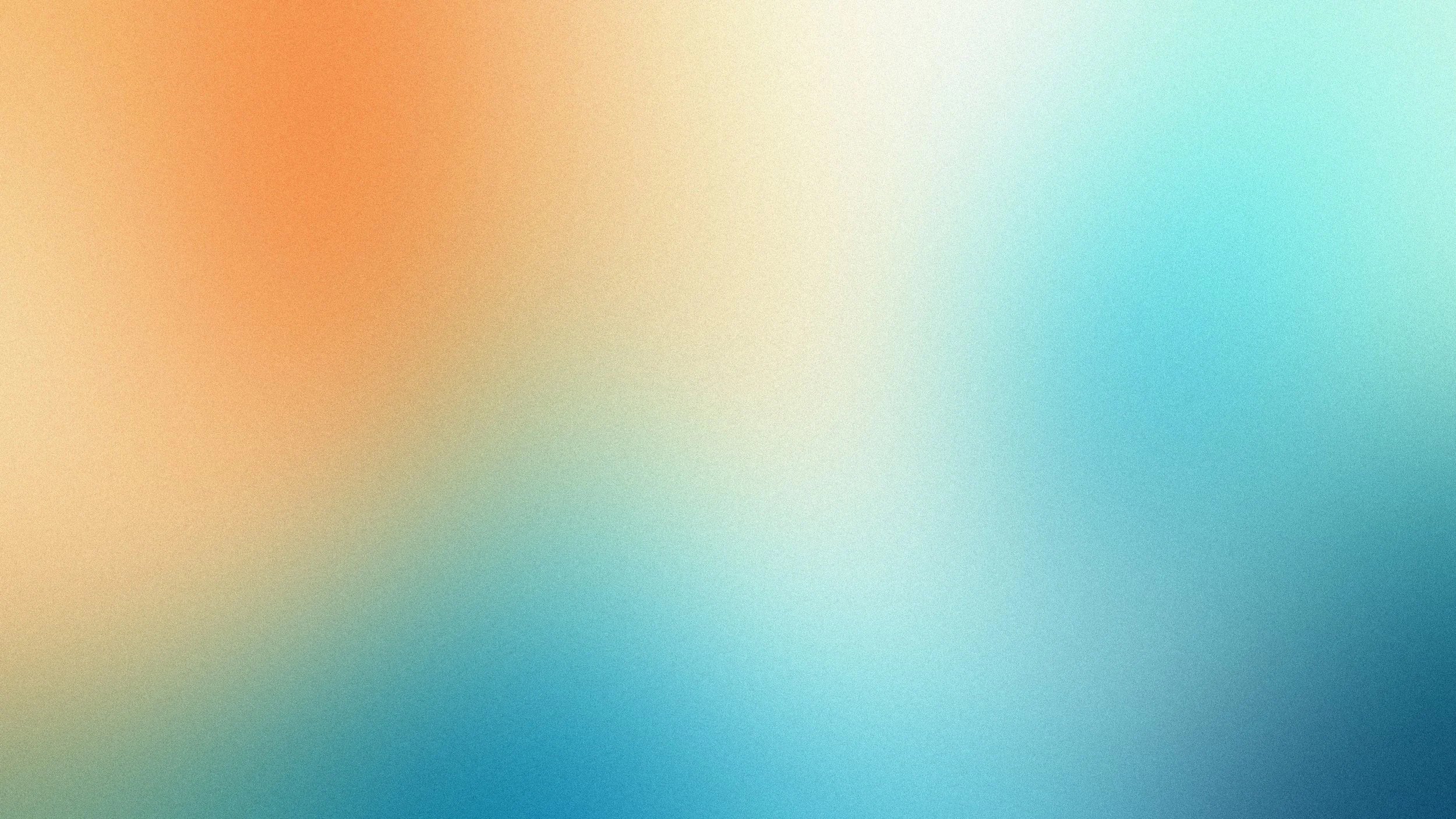 Blurred background with a gradient of warm orange and yellow tones, transitioning to cool blue and cyan hues.