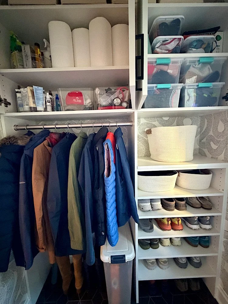 Closet with shelves, hanging jackets, and shoe storage.