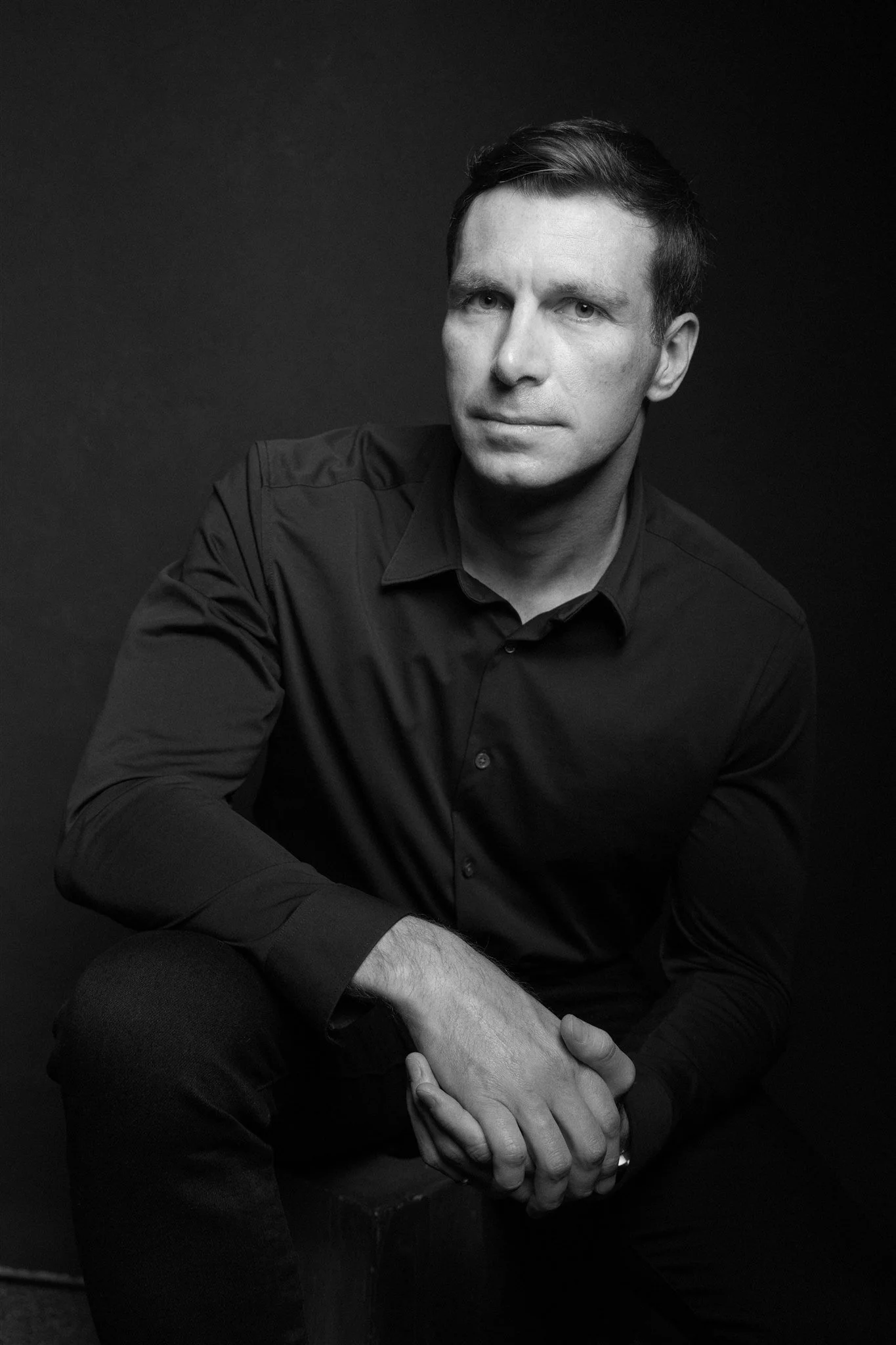 A black-and-white portrait of composer Ryan Stauffer.