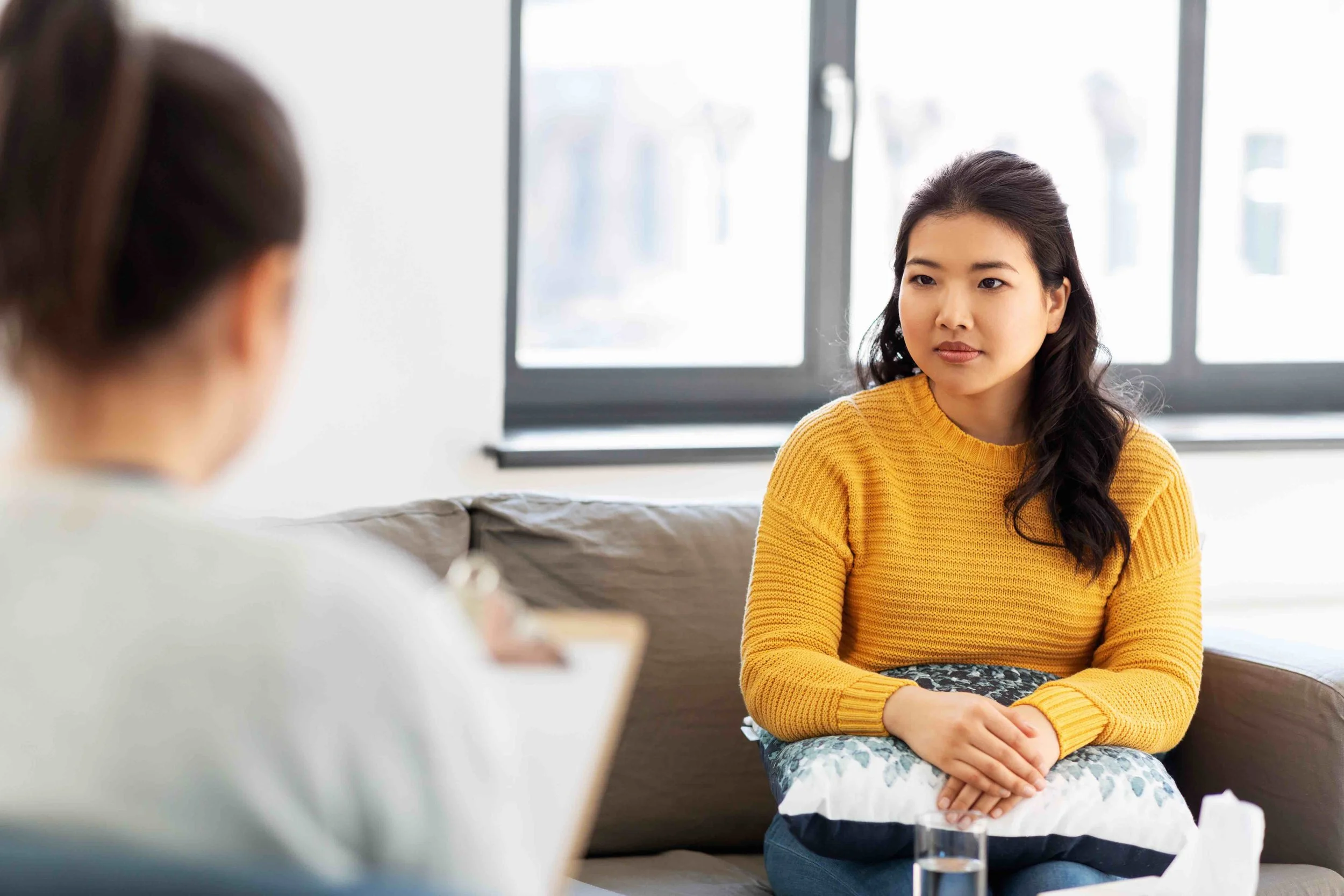Woman in yellow sweater in counseling