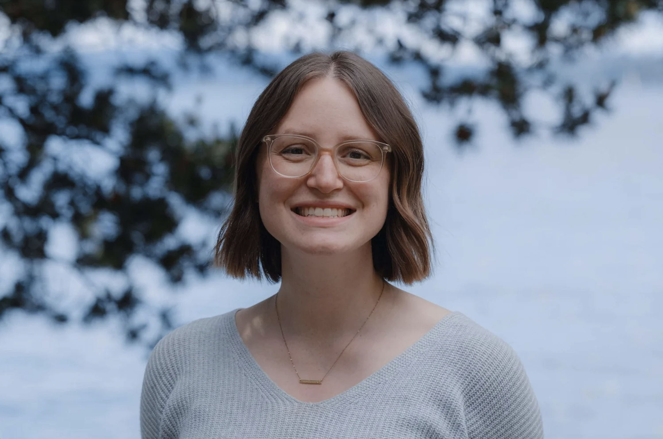 Emily Besaw smiling with trees in background