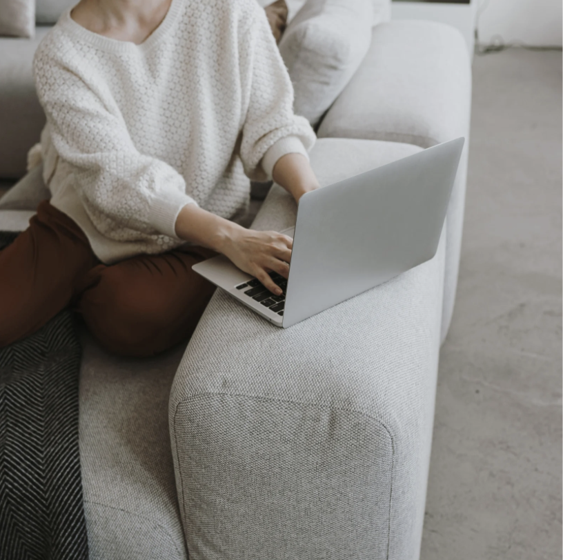 Woman using laptop on couch