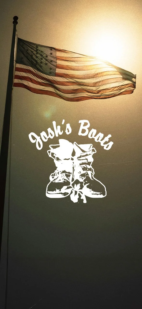 An American flag flying in the wind with the sun behind it. Below the flag, white text reads "Josh's Boots" accompanied by a graphic of a pair of rugged boots with laces and a floral decoration.